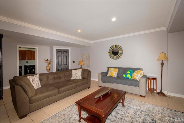 living area featuring crown molding, light tile patterned flooring, separate washer and dryer, and baseboards