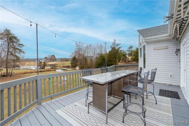 wooden terrace with outdoor dining area