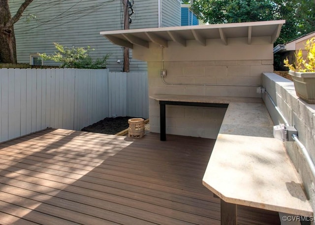 wooden terrace featuring fence