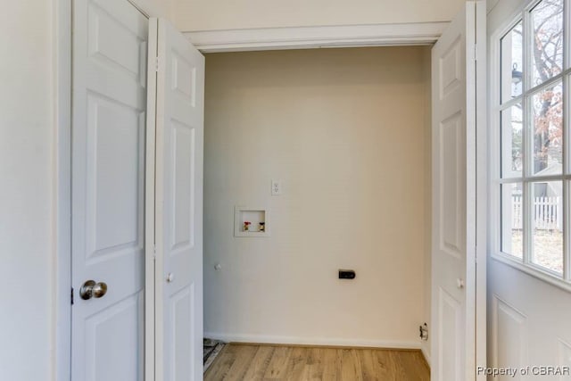 laundry area featuring light wood-type flooring, hookup for an electric dryer, hookup for a washing machine, and laundry area