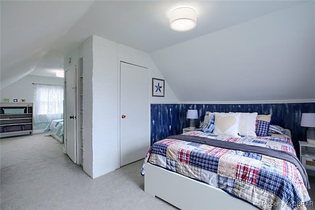 carpeted bedroom featuring vaulted ceiling