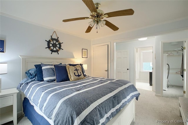 bedroom featuring light colored carpet, baseboards, crown molding, and a ceiling fan