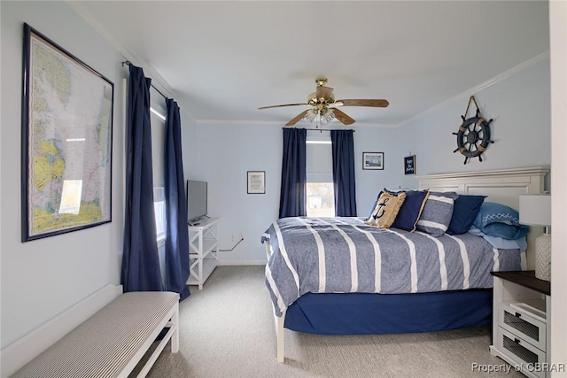 carpeted bedroom with baseboards, a ceiling fan, and ornamental molding