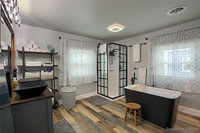 office area with a sink, visible vents, baseboards, and dark wood-type flooring