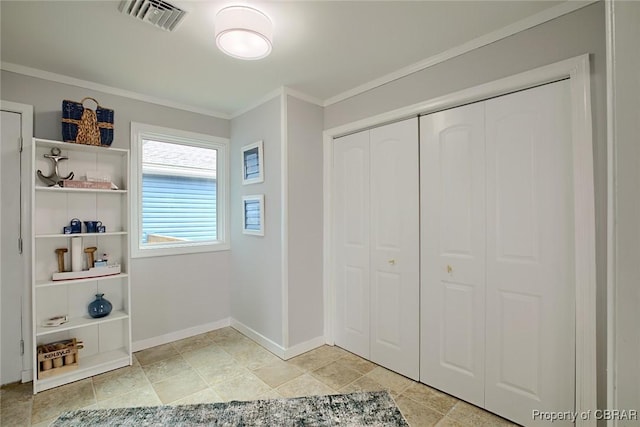 interior space featuring crown molding, baseboards, and visible vents