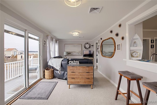 sitting room with visible vents, carpet flooring, baseboards, and ornamental molding