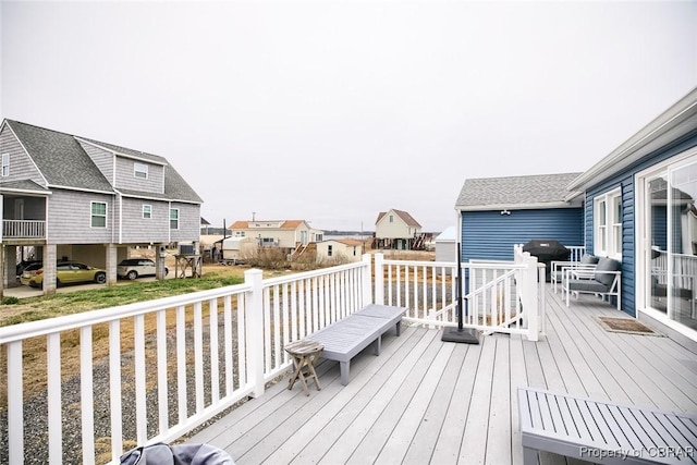 deck featuring a residential view and grilling area