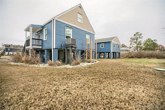 rear view of property featuring a yard