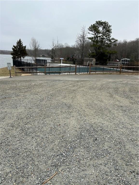 exterior space with a pool and fence