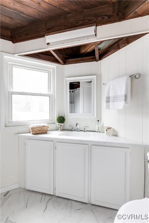 bathroom with beam ceiling, toilet, marble finish floor, wood ceiling, and vanity