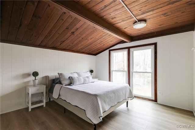 bedroom featuring wooden ceiling, vaulted ceiling with beams, and wood finished floors