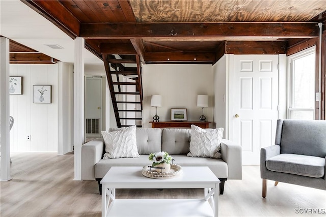 living room with stairway, beam ceiling, light wood-style floors, and wooden ceiling