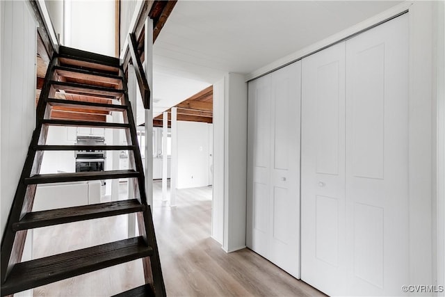 stairs featuring wood finished floors