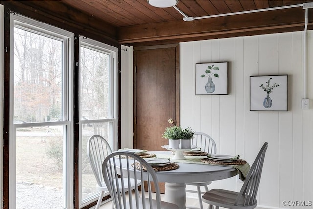 sunroom with beam ceiling and wooden ceiling