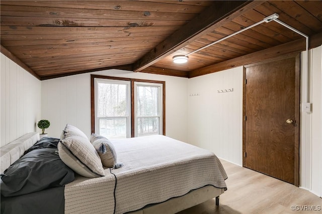 bedroom featuring vaulted ceiling with beams, wood ceiling, and light wood-type flooring