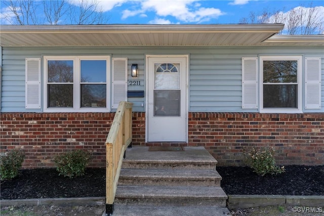 property entrance with brick siding