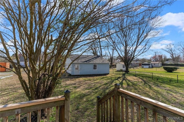 view of yard featuring an outbuilding and fence