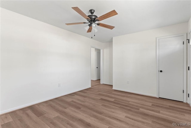 unfurnished bedroom featuring baseboards, light wood finished floors, and ceiling fan