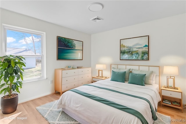 bedroom with visible vents and light wood finished floors