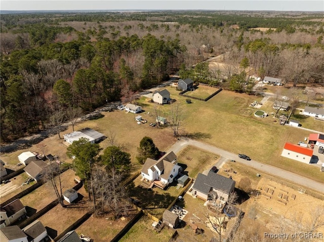 birds eye view of property featuring a forest view