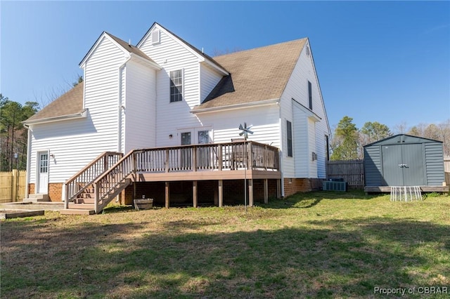 rear view of property featuring central air condition unit, a lawn, a storage shed, an outdoor structure, and a wooden deck