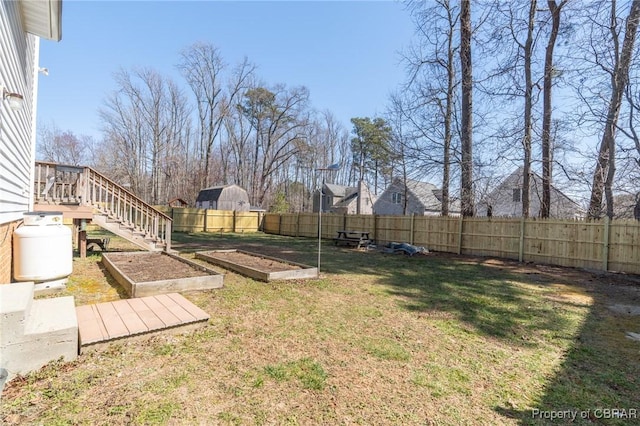 view of yard featuring a garden and a fenced backyard