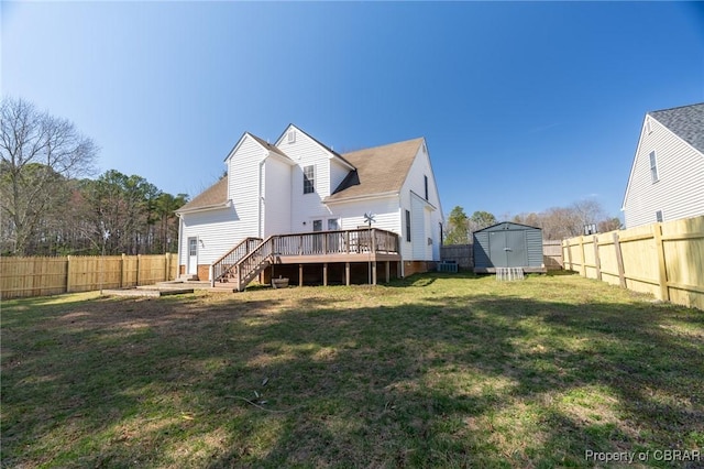 rear view of house with a storage unit, a wooden deck, an outdoor structure, and a fenced backyard