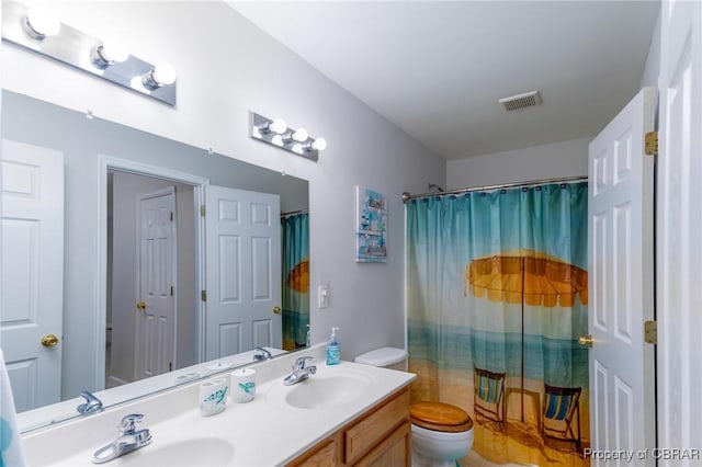 full bathroom featuring double vanity, visible vents, toilet, and a sink