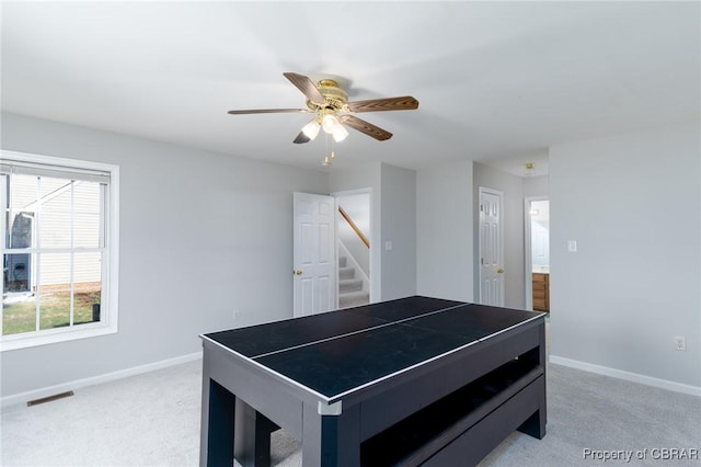 recreation room with visible vents, baseboards, light colored carpet, and a ceiling fan