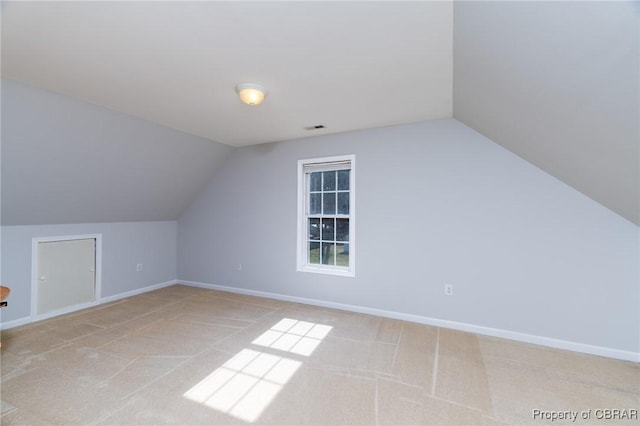 bonus room with visible vents, baseboards, lofted ceiling, and light carpet