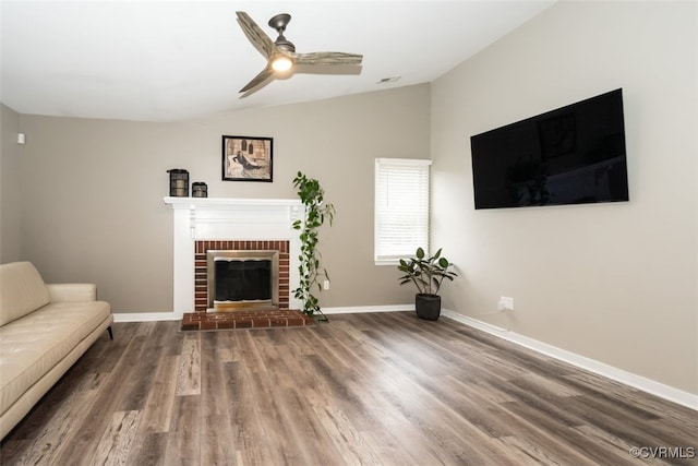 unfurnished living room featuring lofted ceiling, wood finished floors, baseboards, and ceiling fan