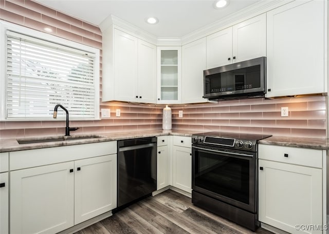 kitchen featuring a sink, tasteful backsplash, appliances with stainless steel finishes, and white cabinets