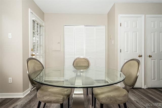 dining room featuring dark wood-style floors and baseboards