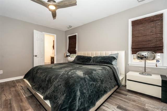 bedroom featuring ceiling fan, baseboards, and wood finished floors