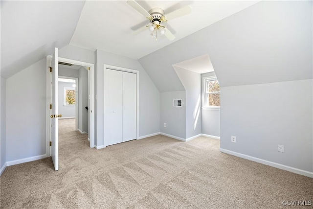 additional living space featuring carpet, baseboards, visible vents, and ceiling fan