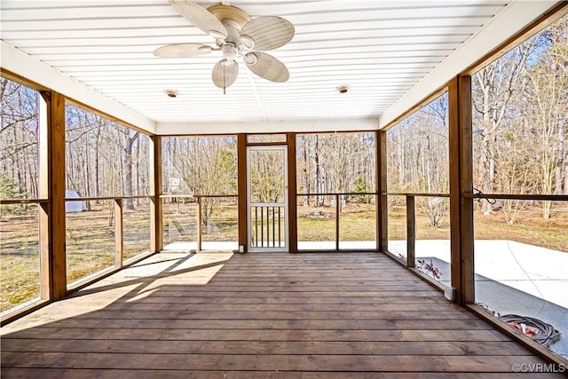 unfurnished sunroom with ceiling fan