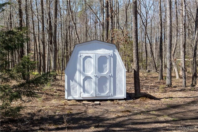 view of shed featuring a forest view