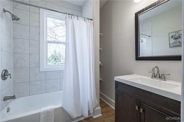 bathroom featuring vanity, plenty of natural light, wood finished floors, and shower / tub combo with curtain