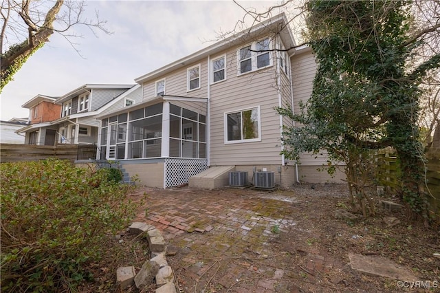 back of property with cooling unit and a sunroom