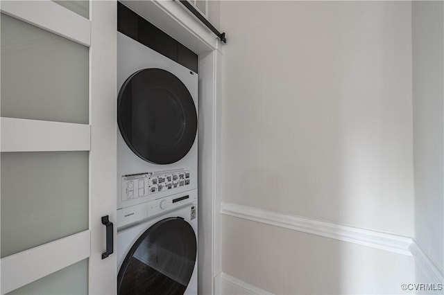 washroom featuring laundry area and stacked washer / drying machine