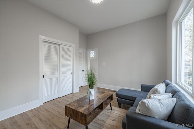 living area featuring wood finished floors and baseboards