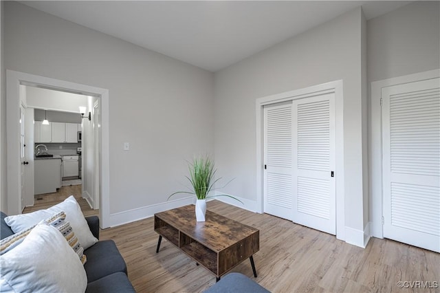 living room featuring wood finished floors and baseboards