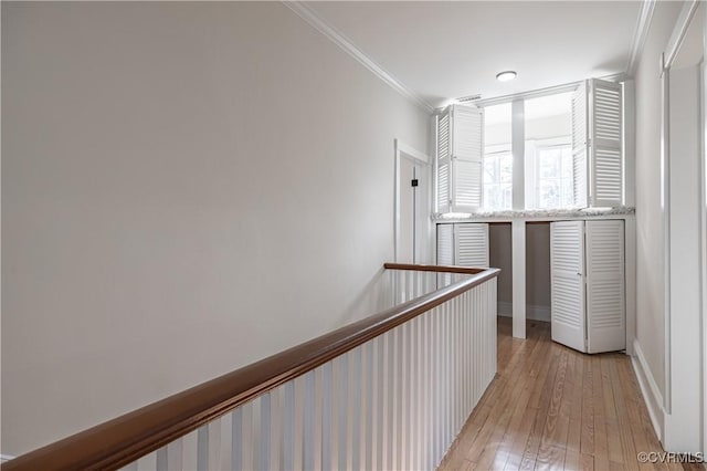 corridor featuring crown molding and light wood-style floors