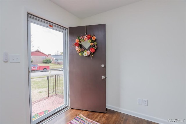 foyer entrance with baseboards and wood finished floors