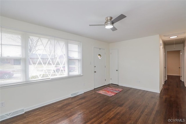 foyer entrance featuring wood finished floors, a ceiling fan, and visible vents