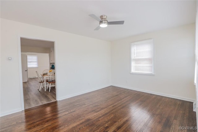 spare room featuring baseboards, a ceiling fan, and wood finished floors