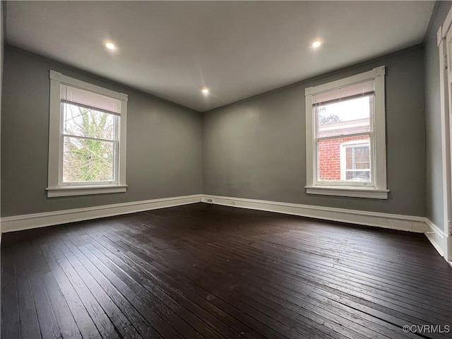 unfurnished room with recessed lighting, dark wood-type flooring, and baseboards