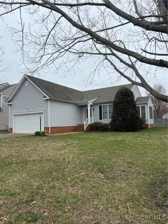 ranch-style home with driveway, a front lawn, an attached garage, and a shingled roof