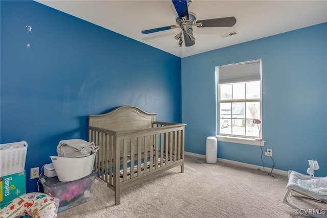 bedroom featuring baseboards, carpet floors, visible vents, and a ceiling fan