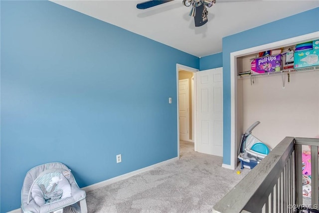 carpeted bedroom with a ceiling fan and baseboards